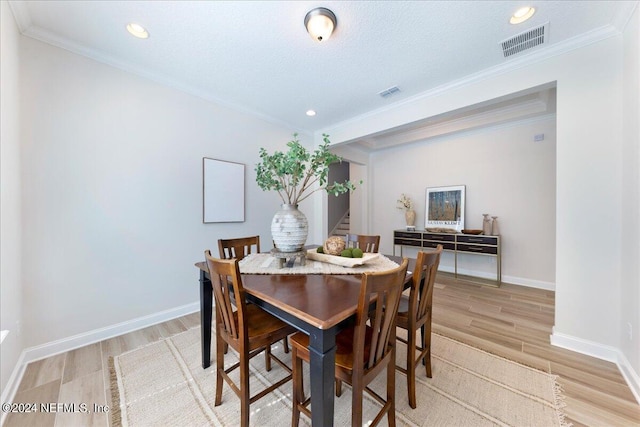 113 Footbridge Rd, Saint Johns, FL 32259 - dining area with baseboards, visible vents, light wood-style floors, and crown molding