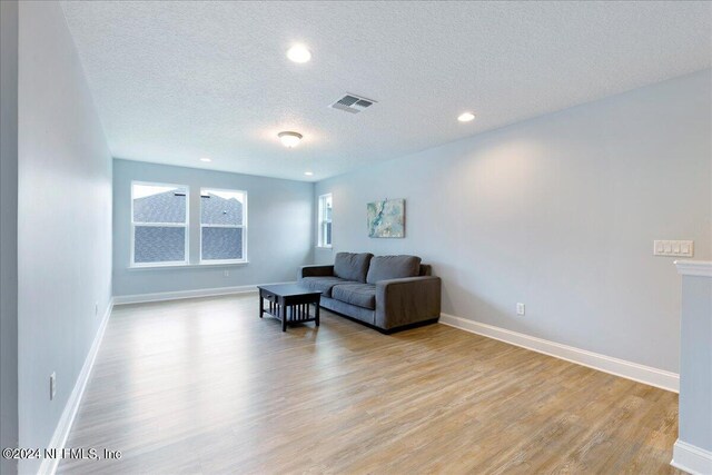 113 Footbridge Rd, Saint Johns, FL 32259 - living room featuring a textured ceiling, light wood-style flooring, visible vents, baseboards, and recessed lighting