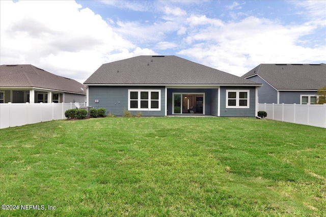 113 Footbridge Rd, Saint Johns, FL 32259 - back of house with a fenced backyard, roof with shingles, and a lawn