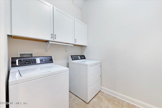 113 Footbridge Rd, Saint Johns, FL 32259 - clothes washing area with light tile patterned floors, washer and clothes dryer, cabinet space, and baseboards