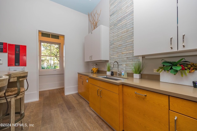113 Footbridge Rd, Saint Johns, FL 32259 - kitchen featuring light countertops, hardwood / wood-style flooring, a sink, baseboards, and white cabinets