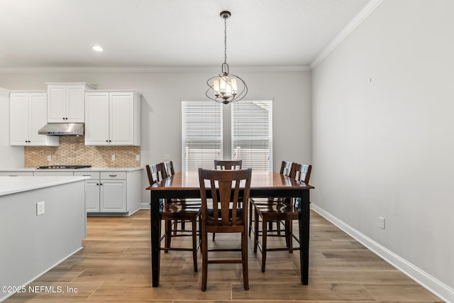 113 Footbridge Rd, Saint Johns, FL 32259 - dining area featuring baseboards, a notable chandelier, light wood-type flooring, and ornamental molding