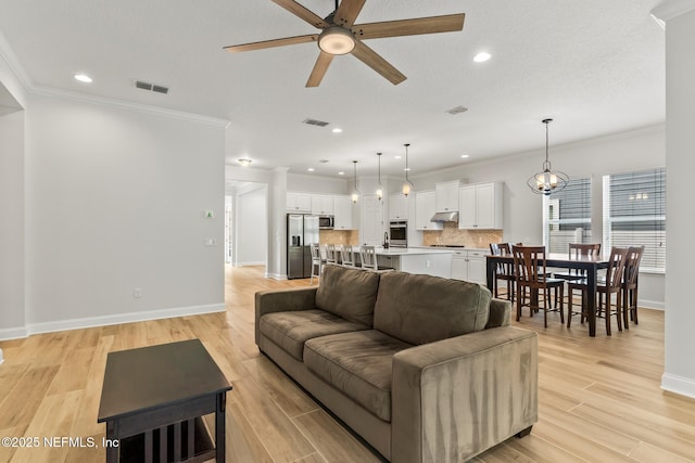 113 Footbridge Rd, Saint Johns, FL 32259 - living area featuring light wood-style flooring, visible vents, crown molding, baseboards, and ceiling fan