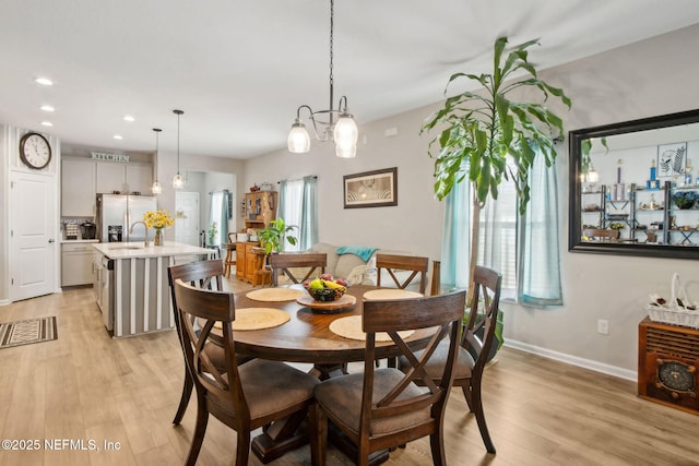 dining space with baseboards, light wood-style floors, and recessed lighting