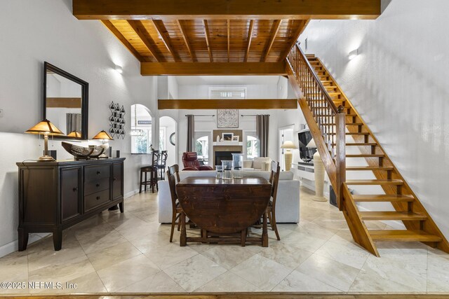 4 Pamela Pkwy, Palm Coast, FL 32137 - dining area with beam ceiling, arched walkways, wood ceiling, and stairway