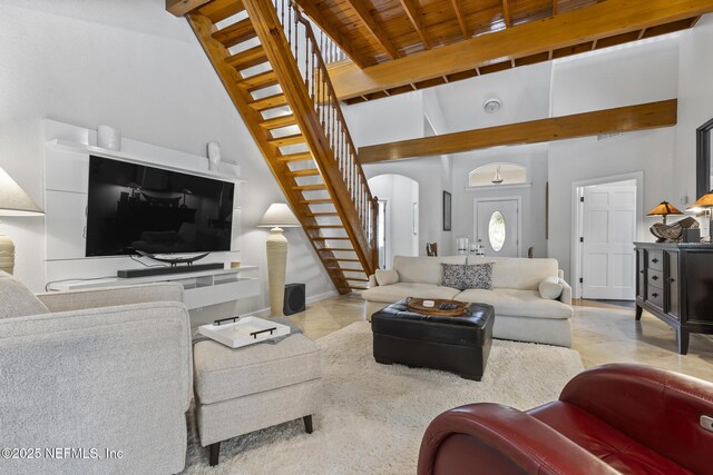 4 Pamela Pkwy, Palm Coast, FL 32137 - living area with high vaulted ceiling, tile patterned floors, stairway, beam ceiling, and arched walkways