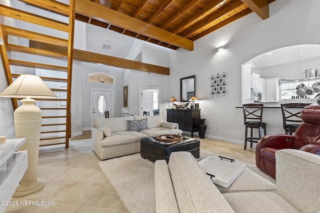 4 Pamela Pkwy, Palm Coast, FL 32137 - living area featuring high vaulted ceiling, baseboards, beam ceiling, arched walkways, and wooden ceiling