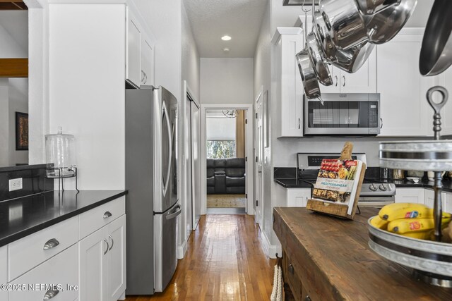 4 Pamela Pkwy, Palm Coast, FL 32137 - kitchen with wooden counters, white cabinets, hardwood / wood-style floors, and stainless steel appliances