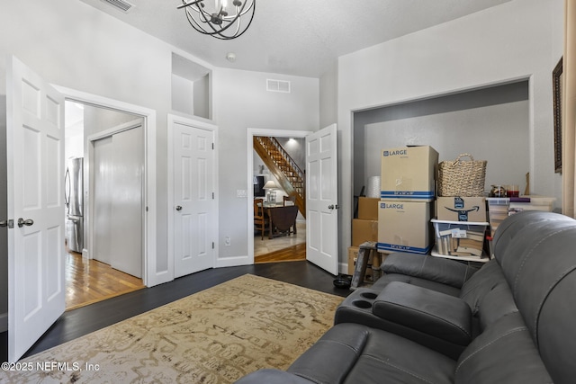4 Pamela Pkwy, Palm Coast, FL 32137 - living room with stairway, a chandelier, dark wood finished floors, baseboards, and visible vents