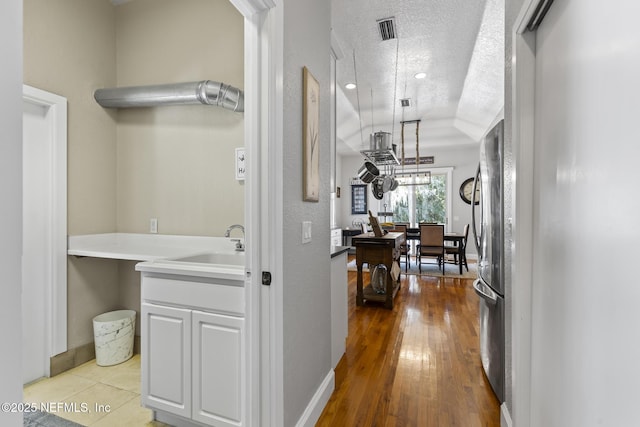 4 Pamela Pkwy, Palm Coast, FL 32137 - corridor with baseboards, a textured ceiling, visible vents, and a sink