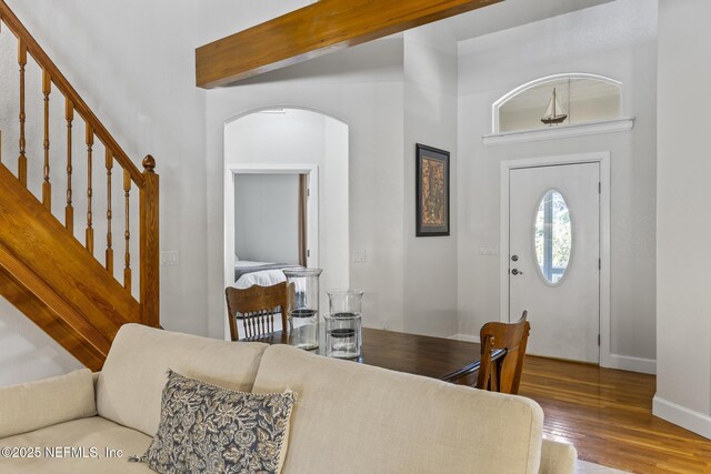 4 Pamela Pkwy, Palm Coast, FL 32137 - entrance foyer featuring beamed ceiling, baseboards, wood finished floors, arched walkways, and a high ceiling