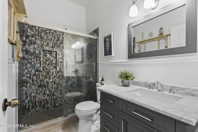 4 Pamela Pkwy, Palm Coast, FL 32137 - bathroom featuring a wainscoted wall, a stall shower, toilet, and vanity