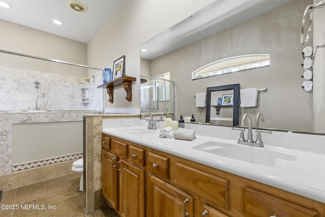 4 Pamela Pkwy, Palm Coast, FL 32137 - bathroom featuring toilet, double vanity, a sink, and a stall shower