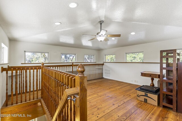 4 Pamela Pkwy, Palm Coast, FL 32137 - hallway with a textured ceiling, an upstairs landing, hardwood / wood-style flooring, recessed lighting, and vaulted ceiling
