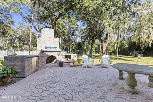 4 Pamela Pkwy, Palm Coast, FL 32137 - view of patio featuring an outdoor brick fireplace and fence