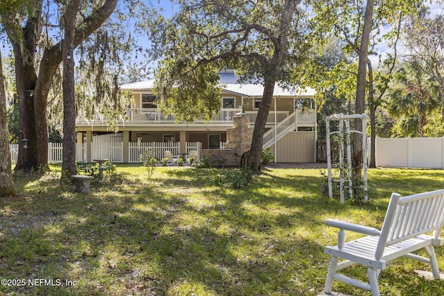 4 Pamela Pkwy, Palm Coast, FL 32137 - view of yard with a fenced backyard, stairs, and a deck