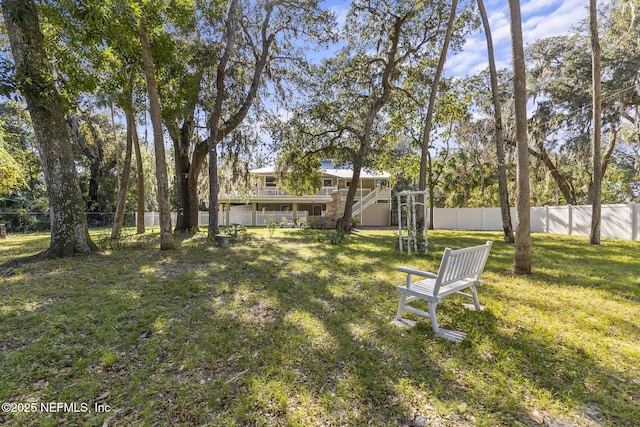 4 Pamela Pkwy, Palm Coast, FL 32137 - view of yard featuring a fenced backyard, a wooden deck, and stairway
