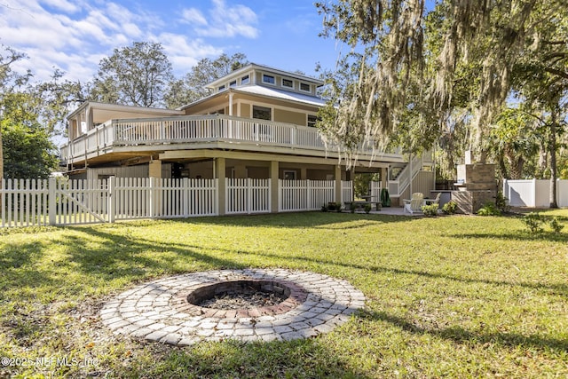 4 Pamela Pkwy, Palm Coast, FL 32137 - rear view of property with a gate, a wooden deck, a fenced backyard, stairway, and a yard