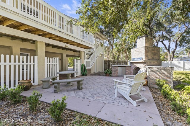 4 Pamela Pkwy, Palm Coast, FL 32137 - view of patio featuring an outdoor brick fireplace, fence, and stairway