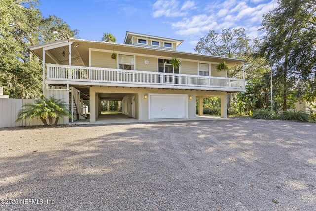 4 Pamela Pkwy, Palm Coast, FL 32137 - coastal inspired home featuring stairs, driveway, covered porch, an attached garage, and a carport
