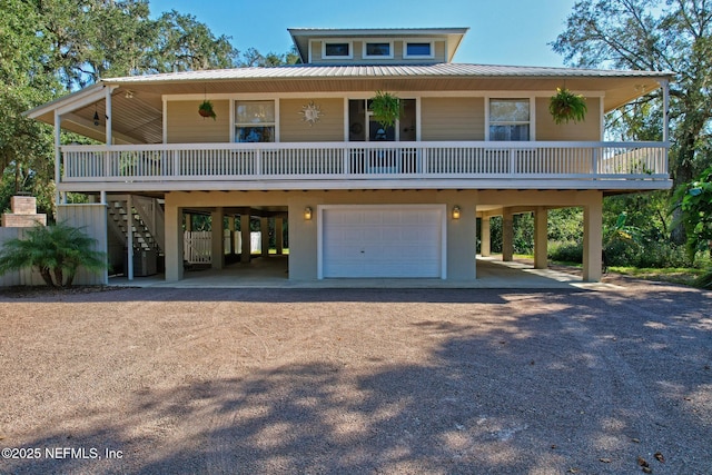 4 Pamela Pkwy, Palm Coast, FL 32137 - beach home featuring covered porch, an attached garage, metal roof, a carport, and dirt driveway