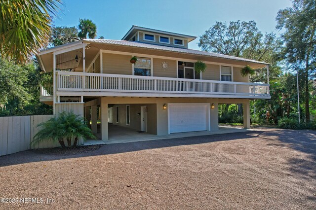 4 Pamela Pkwy, Palm Coast, FL 32137 - coastal home featuring metal roof, stucco siding, a garage, and driveway