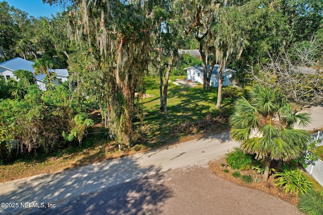 4 Pamela Pkwy, Palm Coast, FL 32137 - exterior space with driveway, fence, and a lawn