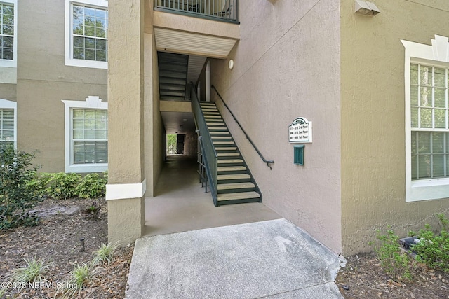 view of exterior entry featuring stucco siding