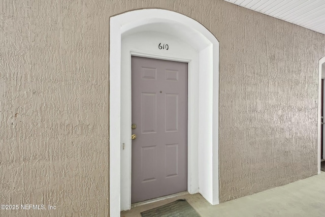 doorway to property with stucco siding
