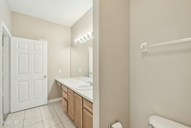 bathroom featuring toilet, tile patterned floors, and vanity