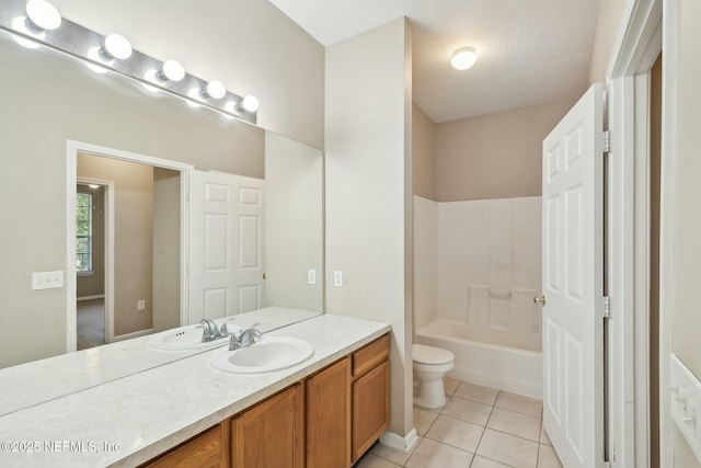 full bath featuring toilet, tile patterned floors, vanity, and shower / bathing tub combination