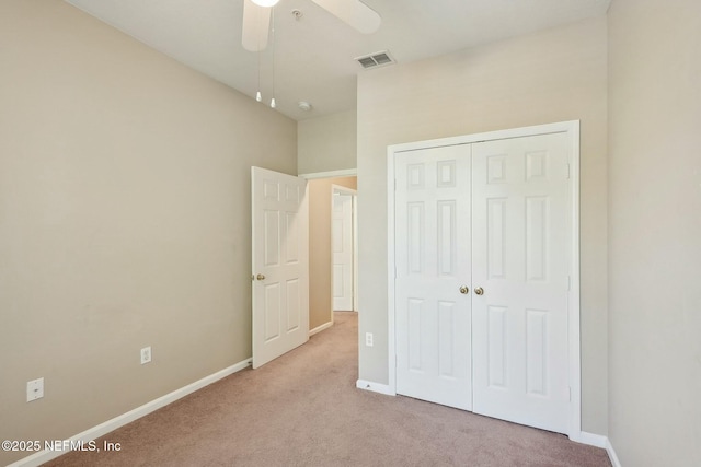 unfurnished bedroom featuring a closet, carpet flooring, baseboards, and visible vents