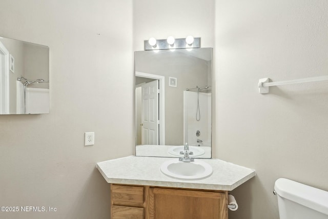 full bath with toilet, vanity, and a shower