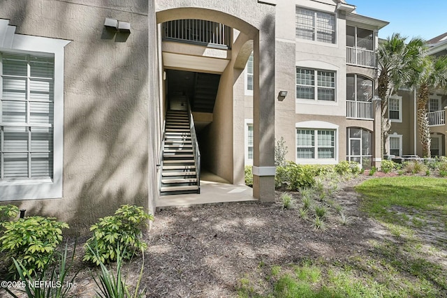 view of exterior entry featuring stucco siding