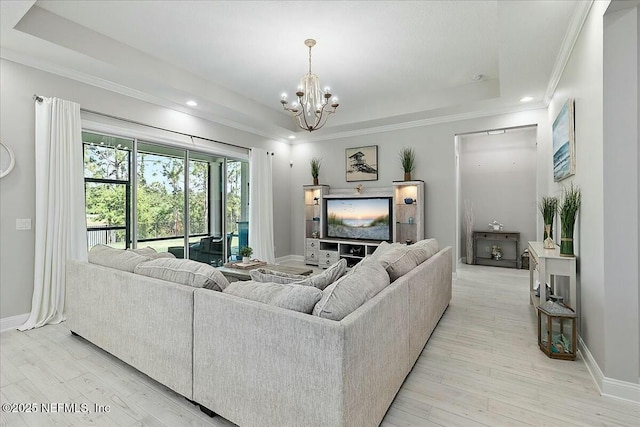 living room featuring ornamental molding, recessed lighting, light wood-style flooring, and a chandelier