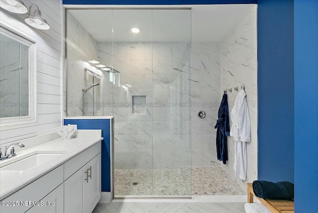 bathroom with a walk in shower and vanity