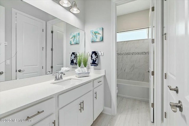 bathroom with shower / bath combination, vanity, baseboards, and toilet