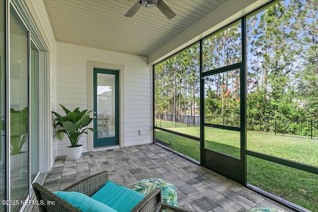 sunroom featuring a ceiling fan