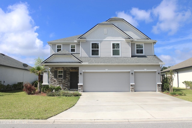 craftsman house featuring stone siding, a garage, concrete driveway, and a front yard