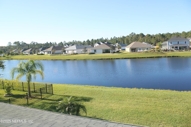 water view featuring a residential view and fence