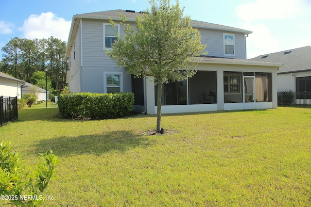 rear view of property featuring a sunroom, fence, a shingled roof, and a yard
