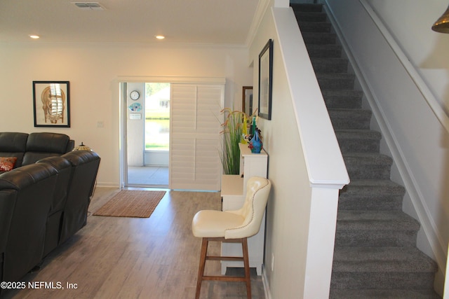 entryway featuring stairs, recessed lighting, wood finished floors, and ornamental molding