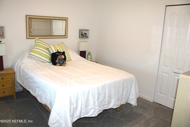 bedroom featuring a closet and dark colored carpet
