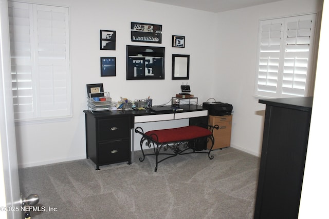 carpeted office featuring baseboards