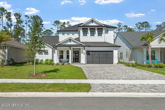 508 Palm Crest Dr, Ponte Vedra, FL 32081 - modern farmhouse featuring board and batten siding, an attached garage, decorative driveway, and a front yard