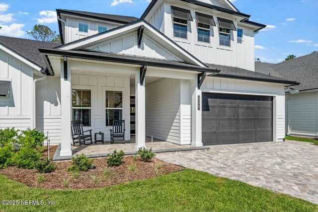 508 Palm Crest Dr, Ponte Vedra, FL 32081 - view of front of property with board and batten siding, a porch, a garage, and decorative driveway