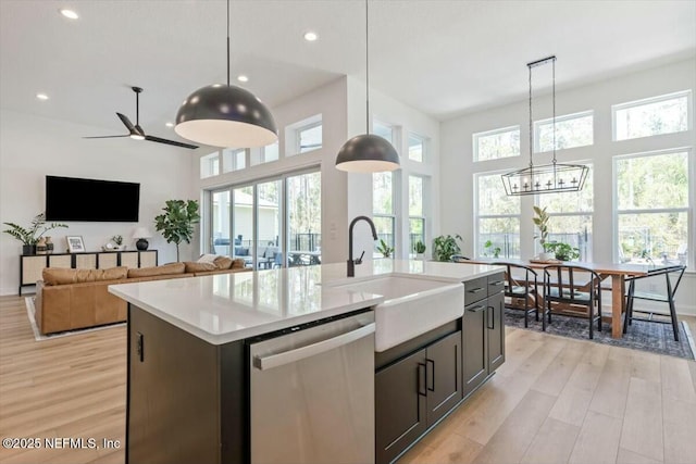 508 Palm Crest Dr, Ponte Vedra, FL 32081 - kitchen with stainless steel dishwasher, a sink, light countertops, light wood-style flooring, and a center island with sink