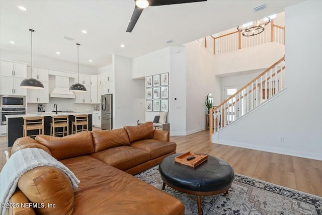 508 Palm Crest Dr, Ponte Vedra, FL 32081 - living room with baseboards, a chandelier, light wood-type flooring, stairway, and recessed lighting