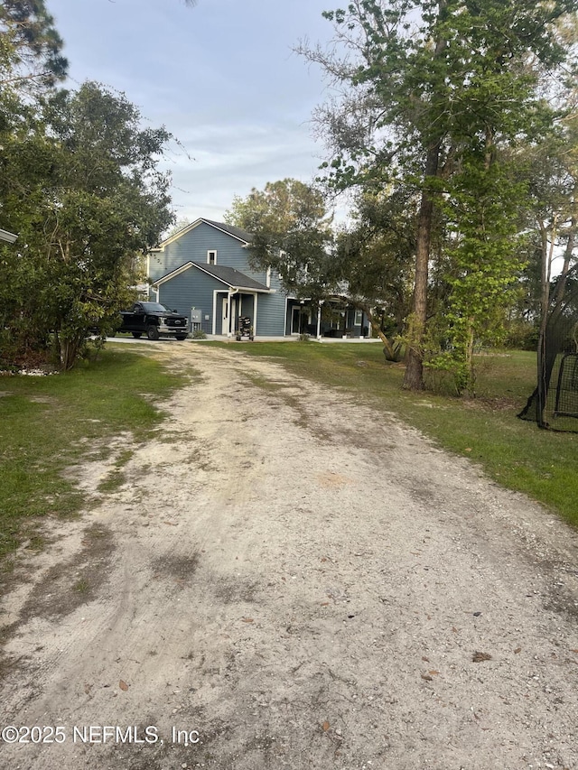 104 W Grandview Dr, East Palatka, FL 32131 - view of front of property featuring a front lawn, a garage, and driveway