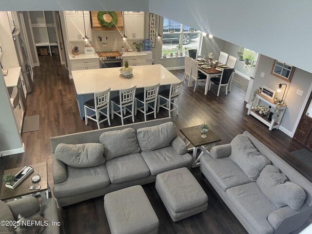 104 W Grandview Dr, East Palatka, FL 32131 - living area with baseboards and dark wood-style floors